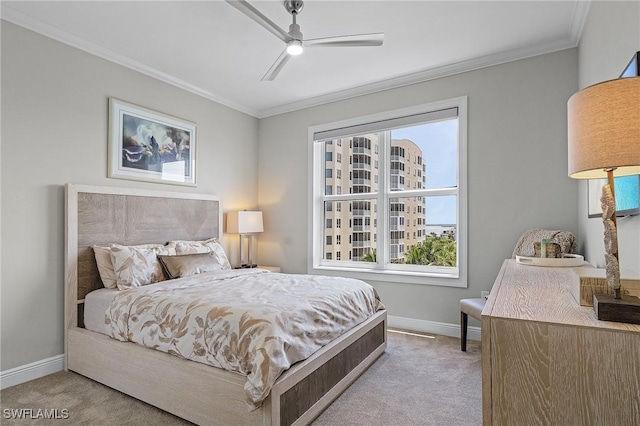 carpeted bedroom with ceiling fan and ornamental molding