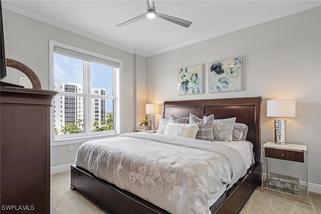 carpeted bedroom featuring ceiling fan and crown molding