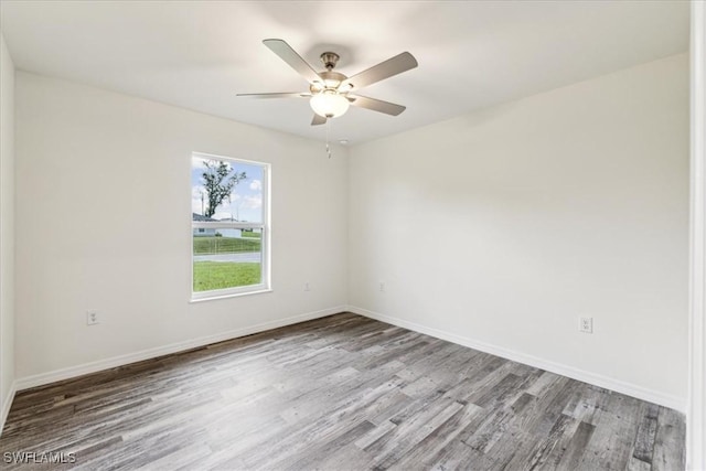 spare room featuring hardwood / wood-style flooring and ceiling fan