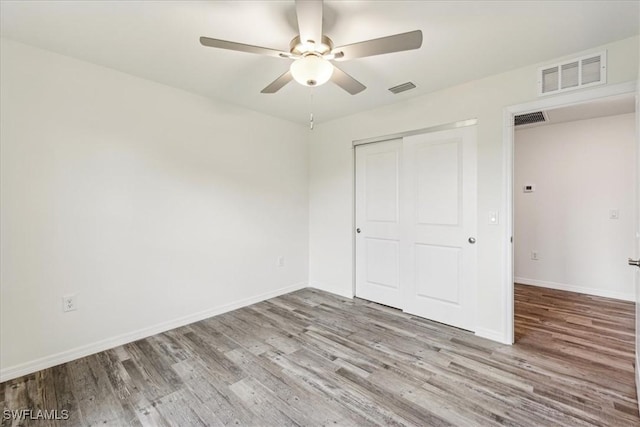 unfurnished bedroom with a closet, ceiling fan, and light wood-type flooring