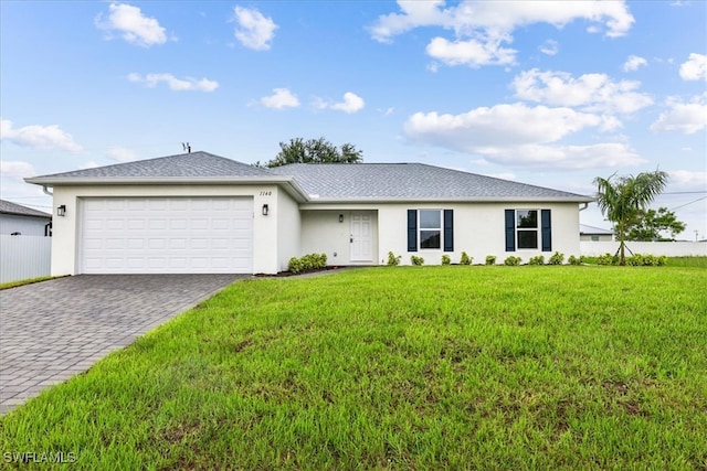 single story home with a garage and a front lawn