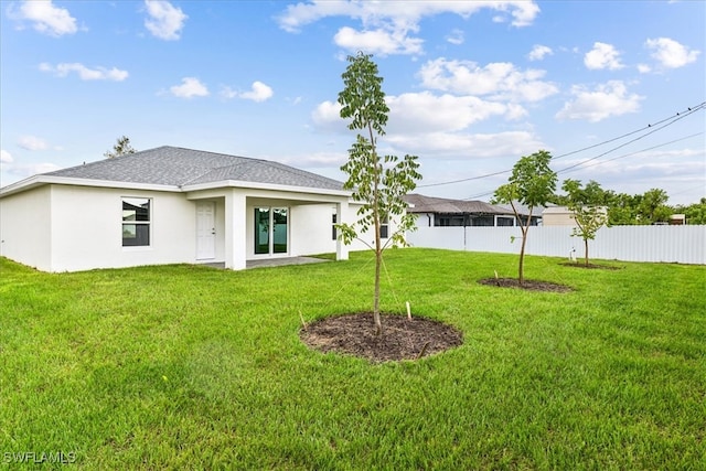 back of house with a lawn