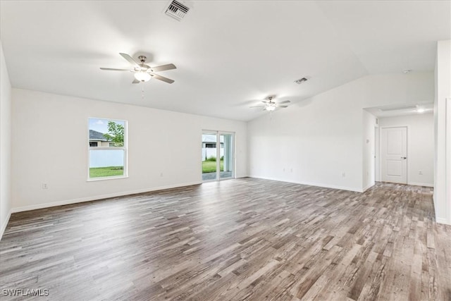 spare room with ceiling fan, lofted ceiling, and light wood-type flooring