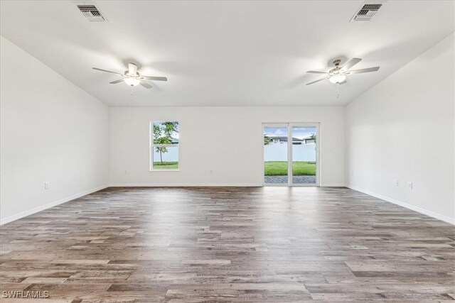 spare room featuring ceiling fan, plenty of natural light, and hardwood / wood-style floors