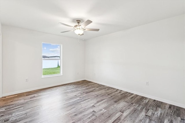 spare room with hardwood / wood-style flooring and ceiling fan