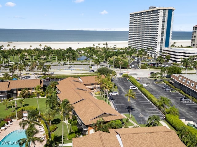 bird's eye view featuring a water view and a beach view