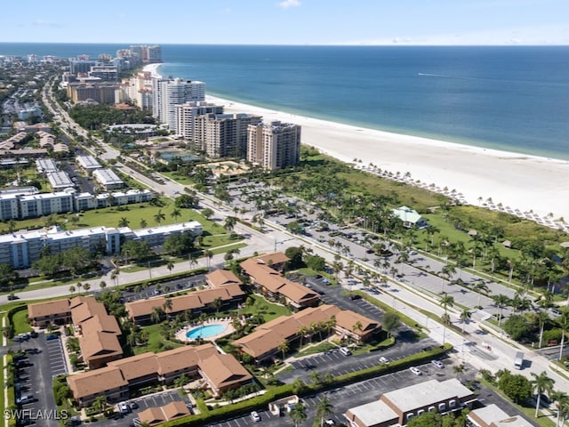 drone / aerial view with a water view and a view of the beach