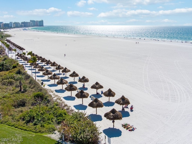 aerial view featuring a water view and a beach view