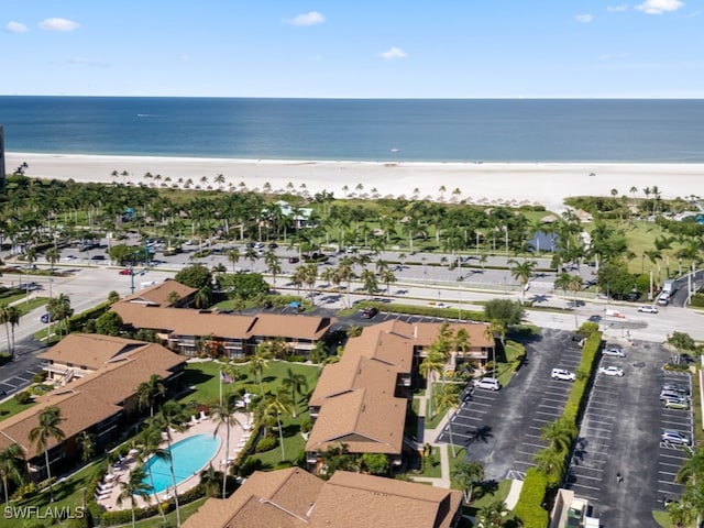 drone / aerial view with a water view and a beach view