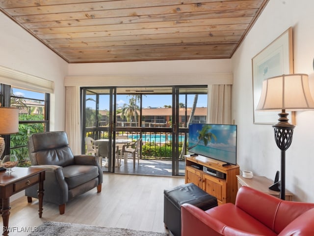 living room featuring wooden ceiling, wood-type flooring, and plenty of natural light