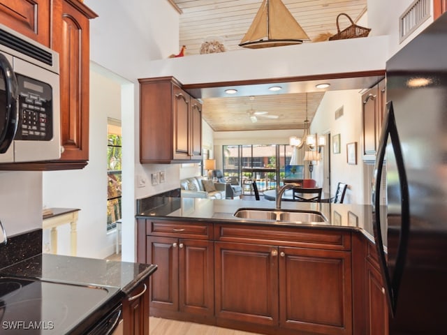 kitchen with light wood-type flooring, black fridge, wooden ceiling, vaulted ceiling, and sink