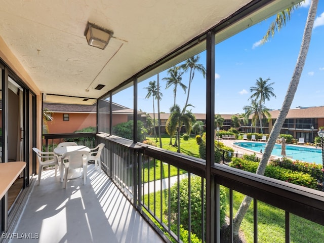 balcony featuring a community pool