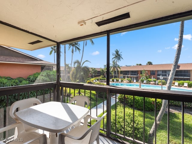 balcony featuring a community pool