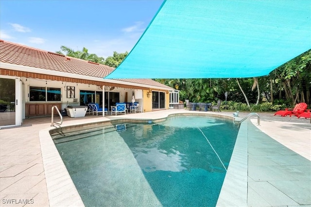 view of swimming pool featuring a patio area