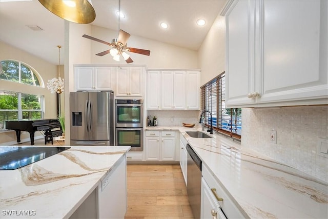 kitchen featuring white cabinets, stainless steel appliances, tasteful backsplash, and sink