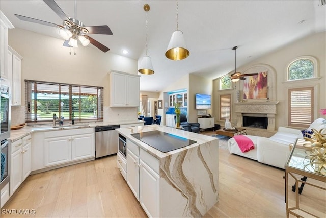 kitchen featuring pendant lighting, white cabinets, light hardwood / wood-style floors, appliances with stainless steel finishes, and a kitchen island