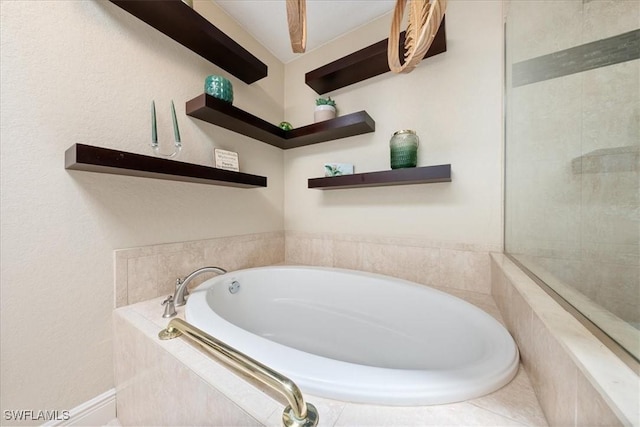 bathroom with a relaxing tiled tub