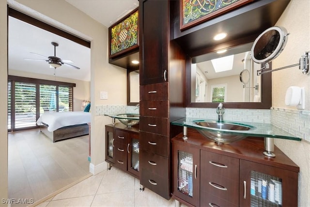 bathroom with tile patterned floors, ceiling fan, vanity, and tasteful backsplash