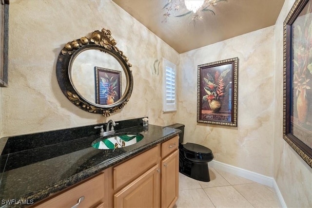 bathroom featuring tile patterned flooring, vanity, and toilet