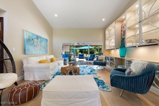 living room featuring light hardwood / wood-style flooring and lofted ceiling