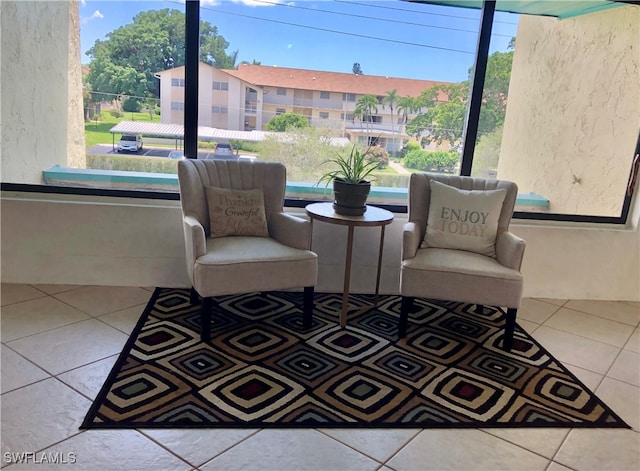 living area featuring plenty of natural light and tile patterned flooring