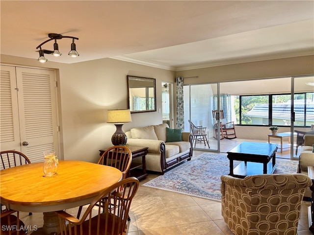 living room featuring ornamental molding and light tile patterned floors