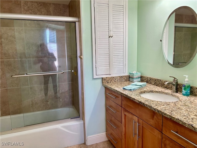 bathroom featuring vanity and shower / bath combination with glass door