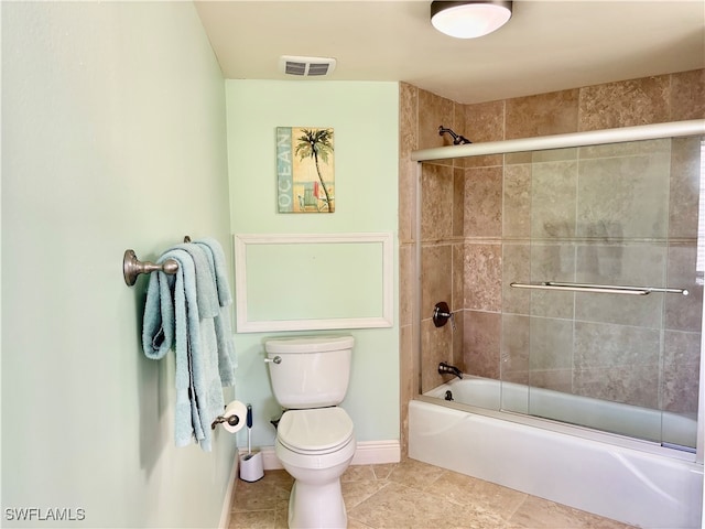 bathroom with toilet and combined bath / shower with glass door