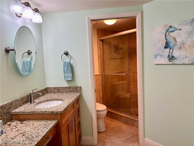 bathroom featuring walk in shower, tile patterned flooring, vanity, and toilet