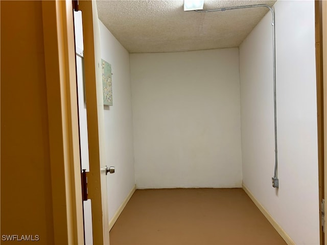 empty room featuring a textured ceiling and concrete floors