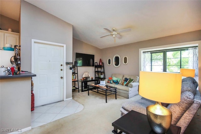 carpeted living room featuring ceiling fan and vaulted ceiling