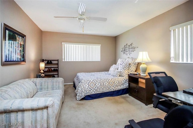 bedroom with a ceiling fan and carpet flooring