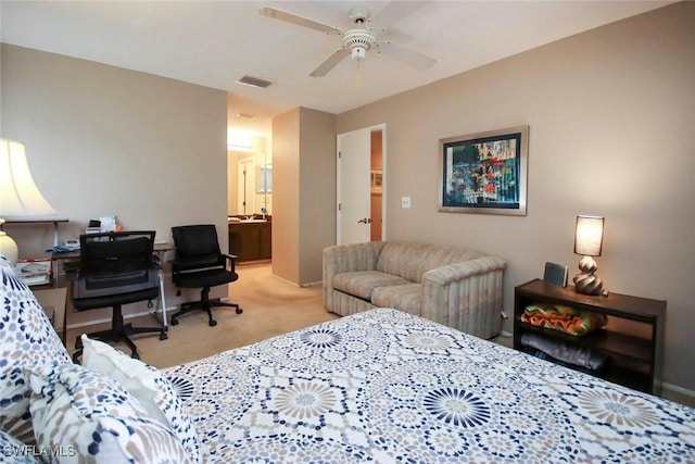 carpeted bedroom with visible vents, ceiling fan, baseboards, and ensuite bathroom