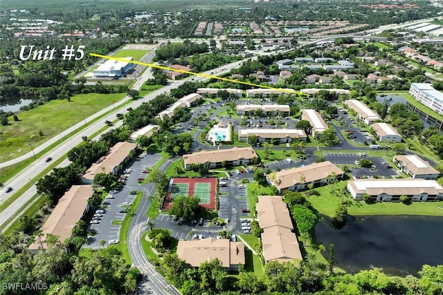 drone / aerial view featuring a water view and a residential view