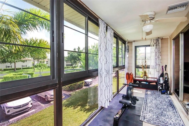 sunroom with visible vents and a ceiling fan