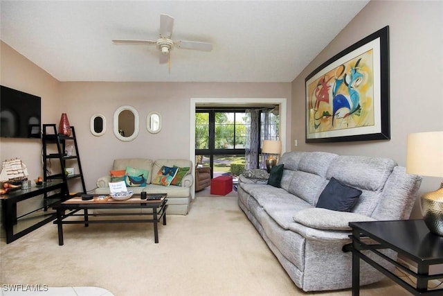 living area with a ceiling fan, carpet, and vaulted ceiling