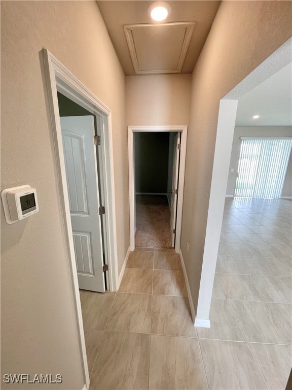 corridor featuring light tile patterned flooring