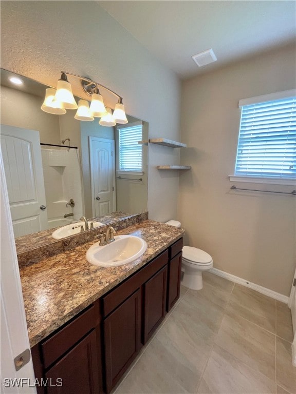 bathroom featuring tile patterned floors, toilet, and vanity