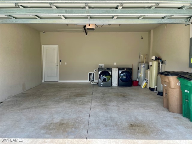 garage featuring electric water heater and washer and clothes dryer