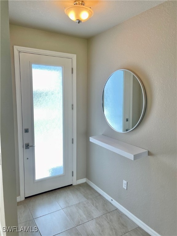 entryway featuring light tile patterned floors and plenty of natural light