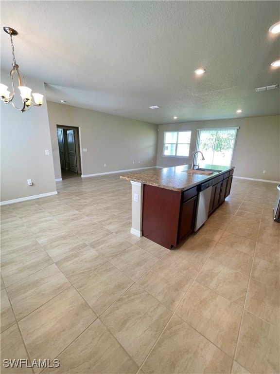 kitchen featuring dishwasher, hanging light fixtures, sink, and light tile patterned floors