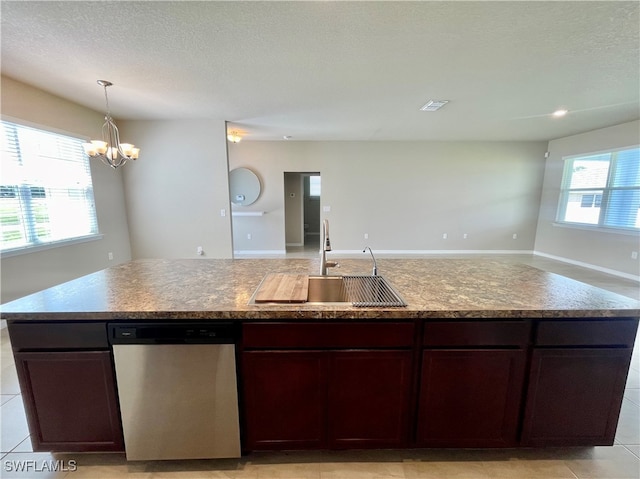 kitchen featuring light tile patterned floors, a wealth of natural light, sink, and stainless steel dishwasher