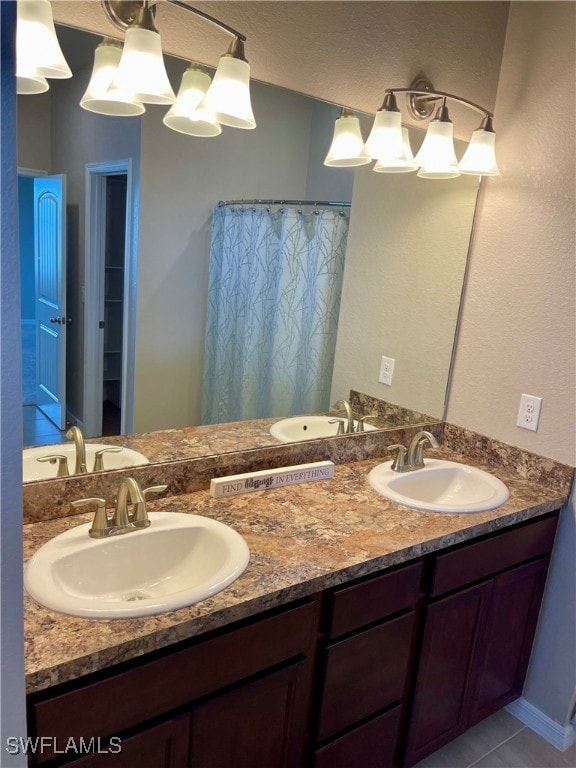 bathroom with dual vanity and tile patterned flooring