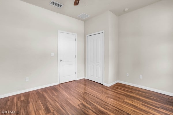 empty room with hardwood / wood-style flooring and ceiling fan