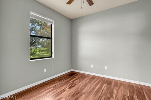 spare room with ceiling fan and hardwood / wood-style floors