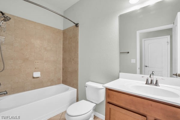 full bathroom featuring vanity, tile patterned flooring, tiled shower / bath combo, and toilet