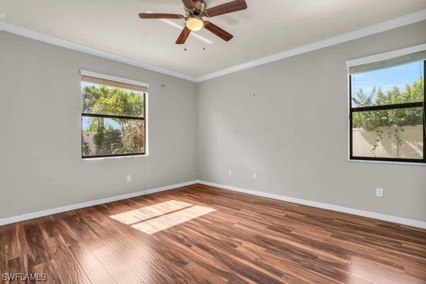 empty room with ceiling fan, hardwood / wood-style flooring, and ornamental molding