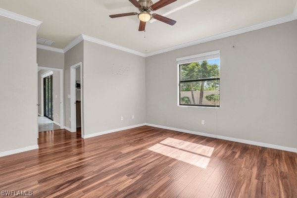 empty room with ceiling fan, hardwood / wood-style floors, and crown molding