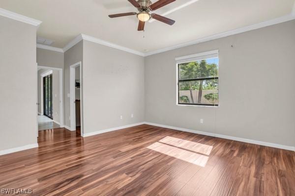 unfurnished room featuring dark wood-style floors, crown molding, baseboards, and a ceiling fan