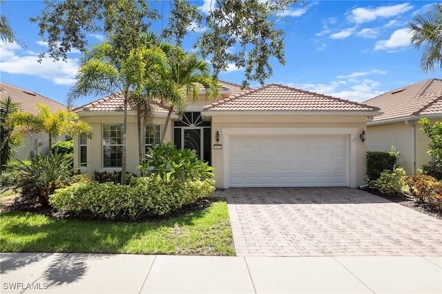 mediterranean / spanish-style house with a garage